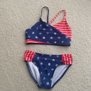 Girl’s 2 piece swim suit. Stars and Stripes print. Size 10/12.